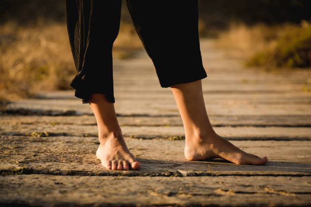 istock Female legs on a wood path 1170916864