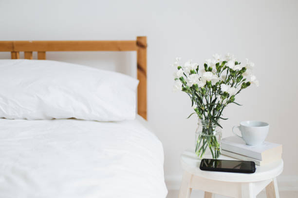 Bouquet of white flowers in a bedroom stock photo