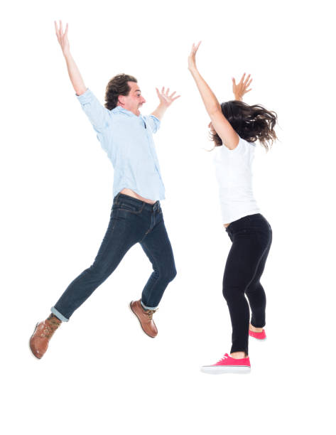 istock Attractive couple jumping for joy 1170923547