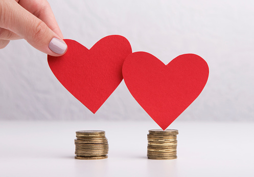 Budget planning. Creative red hearts and money savings for wedding concept on background