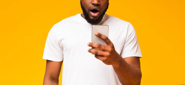 istock Surprised african american guy checking social networks on smartphone 1170925105