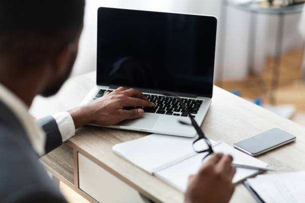istock Black businessman working on laptop on his workplace 1170925176