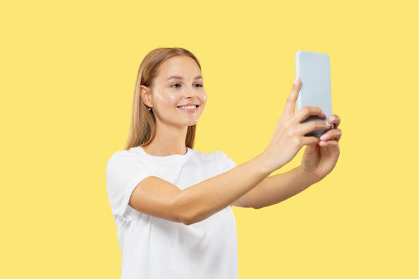 istock Caucasian young woman's half-length portrait on yellow background 1170925249