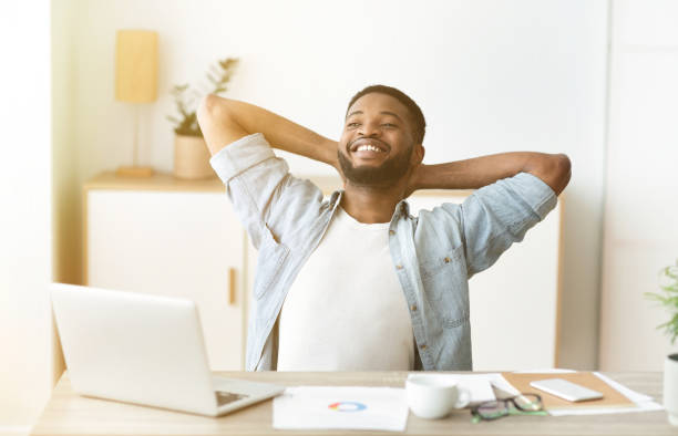 istock Work done. Smiling black freelancer resting after finishing the project 1170926273