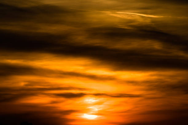 Stormy dramatic sky background with yellow red and orange clouds. Sunset skyline. Storm on the beach