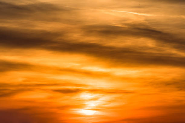istock Huge sun behind stormy dramatic sky. background with yellow red and orange clouds. Sunset skyline. Storm on the beach 1170926795