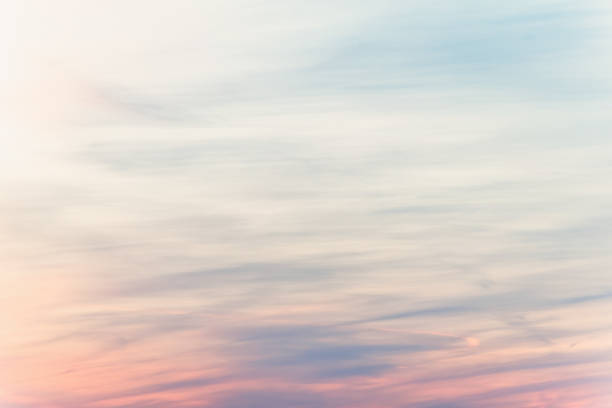 sunset background. sky with soft and blur pastel colored clouds. sunshine through the gradient cloud on the beach resort. nature. sunrise.  peaceful morning