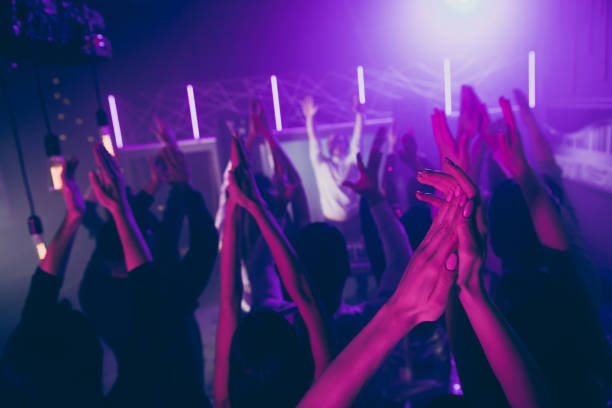 istock Cropped view blurred photo of people wave raise hands gathering look stage performance discotheque 1170930367
