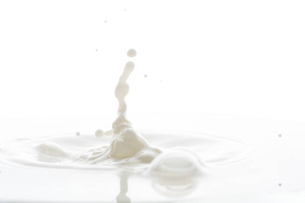 istock splash from falling drops of white milk on a white background 1170933616