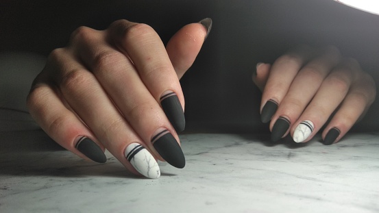 Matte black gel polish with geometric designs