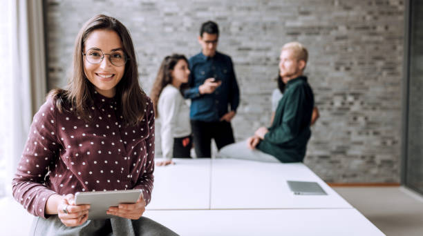 istock Smiling woman with a table t in office 1170934649