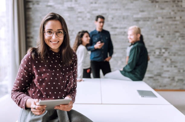 Smiling woman with a table t in office