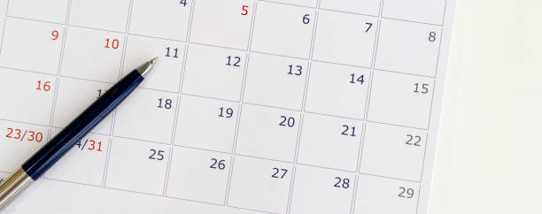 close up top view soft focus on pen over calendar 2020  at office table at  for make appointment or remind important date,business office supply concept
