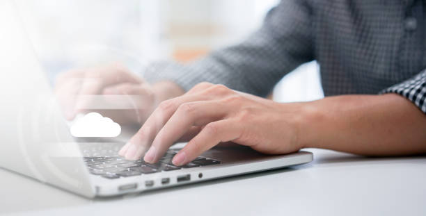 close up computer programmer man hand typing on keyboard for transfer or synch data upload and download from cloud computing with virtual interface in operation room, technology business concept close up computer programmer man hand typing on keyboard for transfer or synch data upload and download from cloud computing with virtual interface in operation room, technology business concept in synch stock pictures, royalty-free photos & images