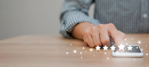 istock close up on man hand pressing on screen smartphone with level five star rating feedback to give good  job (4 star) to provider service concept 1170936577