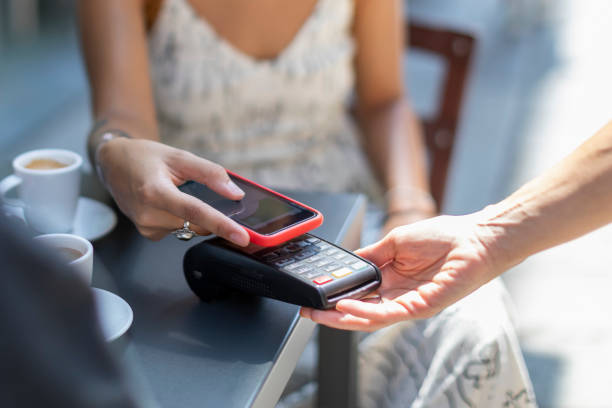 istock Young Woman Paying With Mobile Contactless App at Cafe 1170936961
