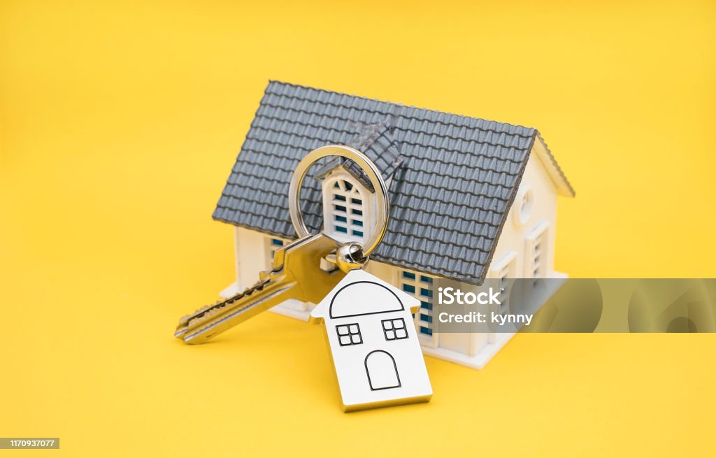 House Key And Key chain On yellow background Key Stock Photo