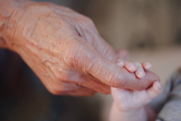 Young little boy shaking hands with old man