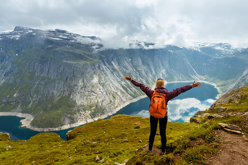 Norway hike. Sporty woman on top of rock near Trolltunga