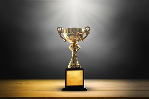 gold star trophy on gold background