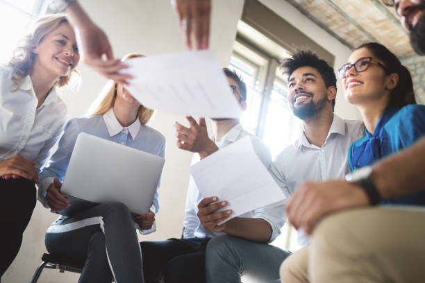 istock Successful happy group of people learning software engineering and business during presentation 1170942055