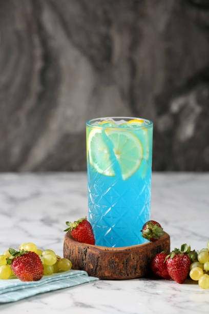 istock Summer refreshing cold drink, isotonic blue water in bottles, gray table background, selective focus 1170942155
