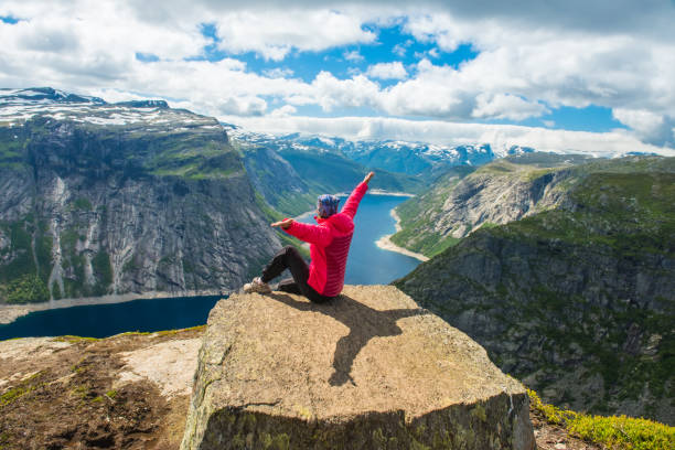 istock Sporty woman posing on Trolltunga Norway 1170944817