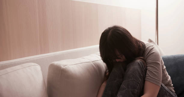 istock woman feel depressed on sofa 1170945033