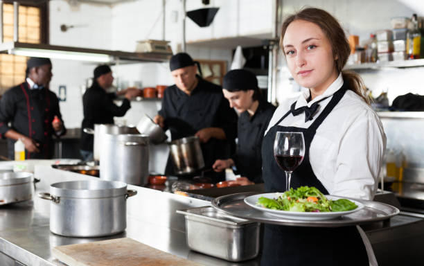 istock Professional waitress holding serving tray at restaurant kitchen 1170946431
