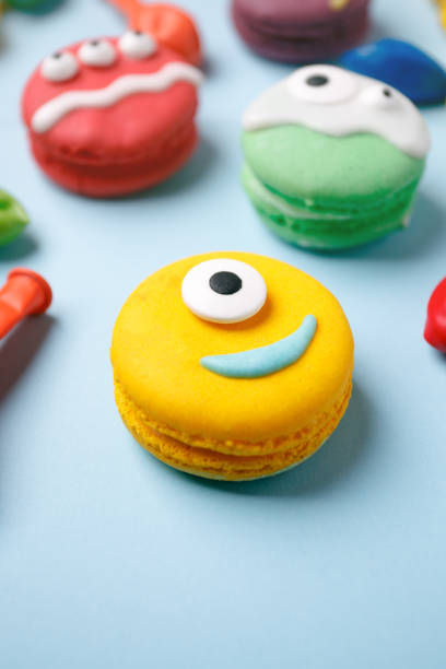 istock Delicious Halloween macaroons set with bright decorations made of confectionery mastic. Halloween sweets, homemade confectionery, holiday food, trick or treat concept 1170949230