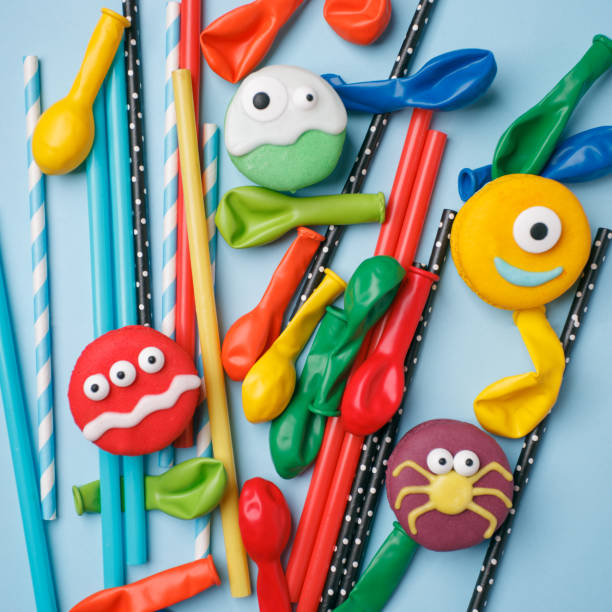 istock Bright birthday halloween background with sweets and decorations on blue surface, copy spase, funny monster food 1170949237