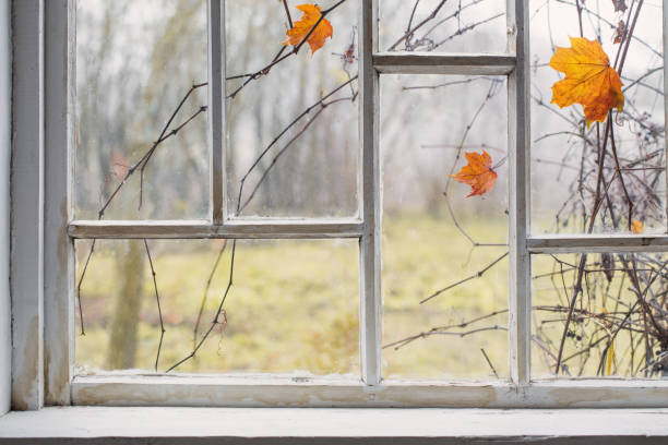 autumn landscape on old window stock photo
