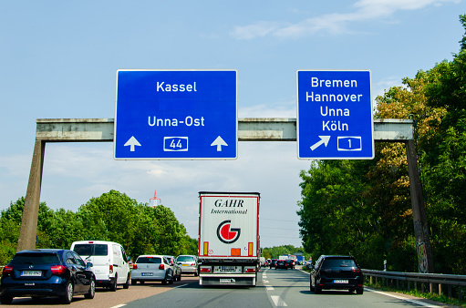 North Rhine-Westphalia, Germany - August 2, 2019: Road traffic on the German autobahn 1 with road signs. Cars ride on the German autobahn.