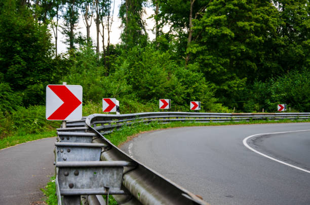 istock Road sign direction dangerous turn. 1170953018