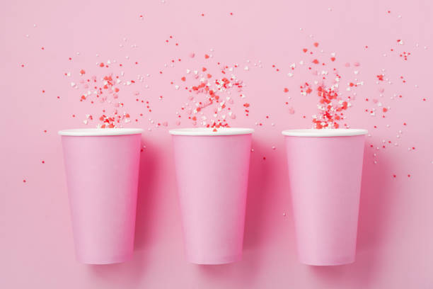 istock Three pink paper cup of coffee on pink paper light background. Zero waste concept. Flat lay. 1170957338