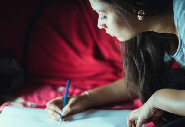 Indian teenager girl working at night at home indoor shoot. location Delhi