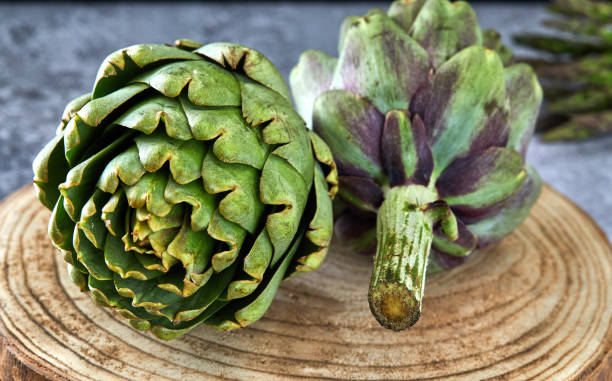 istock Artichokes with greens on a wooden stand 1170962913