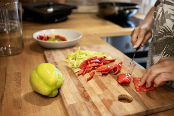 istock Woman cutting paprika in kitchen sink 1170962924