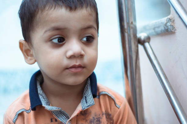 istock cute little boy thinking and looking away 1170963152