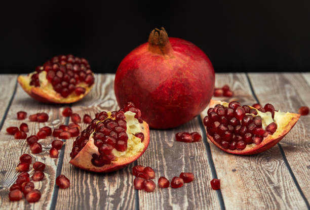 istock Ripe pomegranate fruit on old brown wooden 1170963214