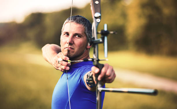 Archery. Archer exercise with the bow. Sport, recreation concept