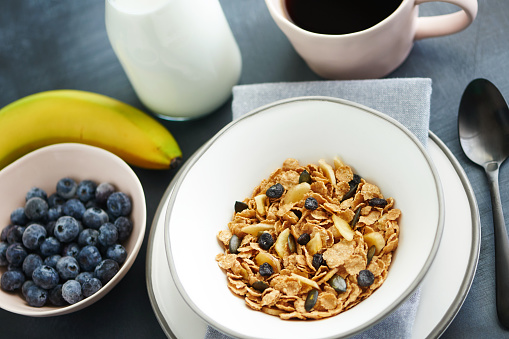 Blueberry and banana breakfast cereal still life with milk and coffee