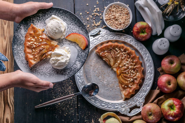 Still life: a girl holds a homemade pie with apples, peaches and ice cream. Close-up Still life: a girl holds a homemade pie with apples, peaches and ice cream. Close-up ice pie photography stock pictures, royalty-free photos & images