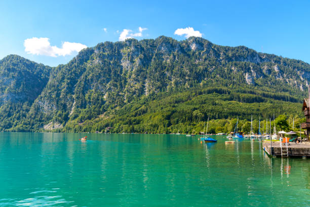 Attersee lake in the Salzkammergut, alps mountains Upper Austria Beautiful view on Attersee lake im Salzkammergut, alps mountain, boat, sailboat in by Unterach. Upper Austria, nearby Salzburg. attersee stock pictures, royalty-free photos & images