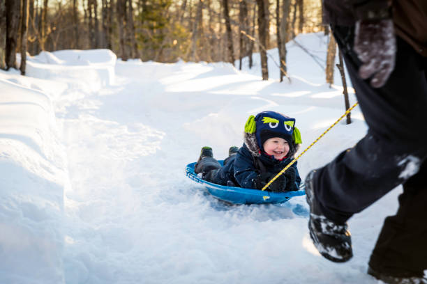 istock Grandfather Pulling Grandson on Sled in Winter 1170967472
