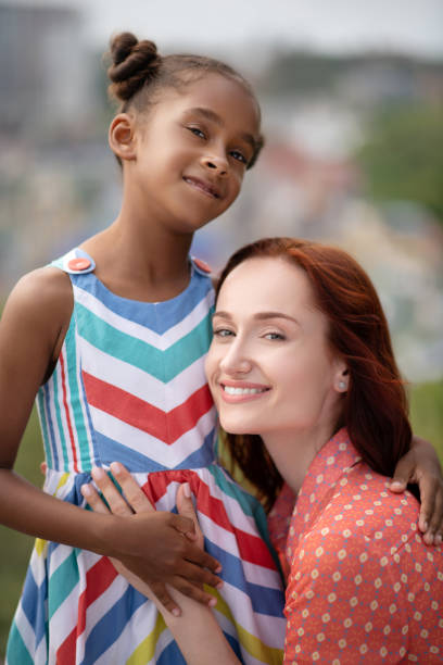 istock Adoptive mother standing near lovely daughter 1170967620