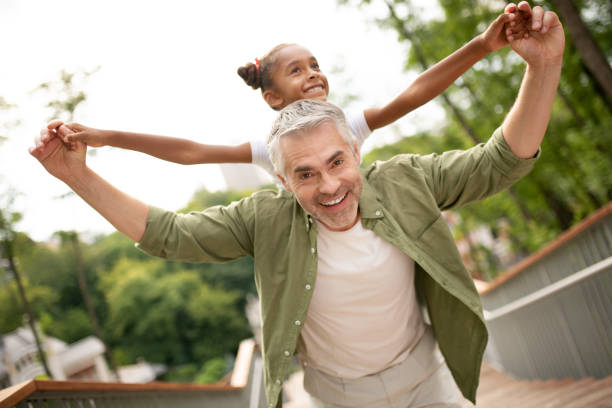 istock Man feeling amazing playing with foster daughter 1170967668