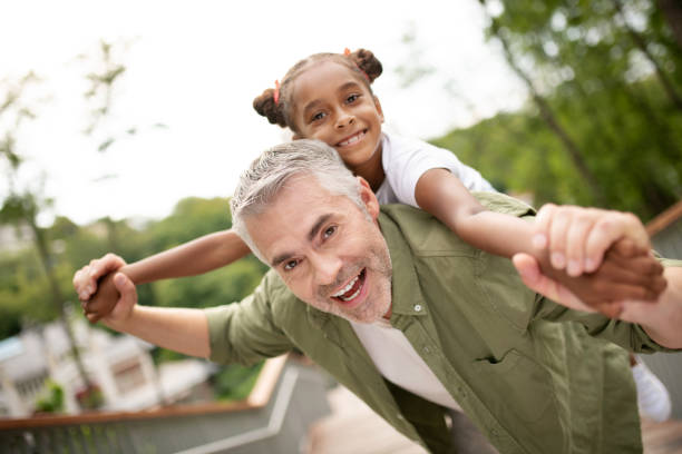 istock Grey-haired daddy having fun with his cute lovely daughter 1170967674