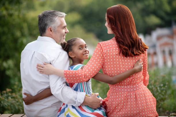 istock Adopted girl feeling happy while meeting her new parents 1170968300