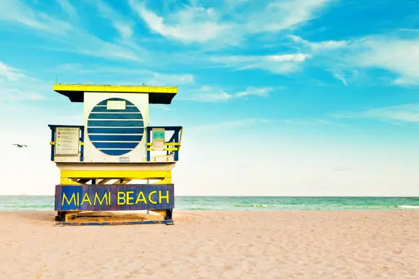 A lifeguard post along the horizon of the tropical Miami Beach, with blue sky and copy space above.